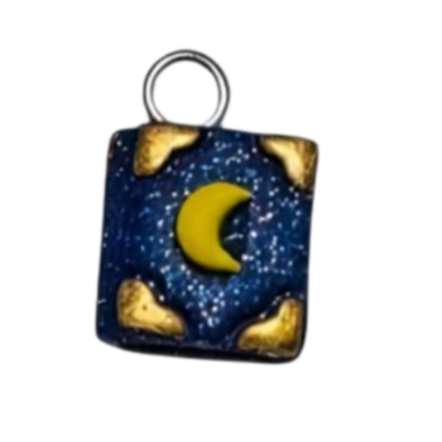 A small square charm with a silver-tone loop at the top, featuring a crescent moon design in yellow and blue with a textured pattern, set against a plain white background.